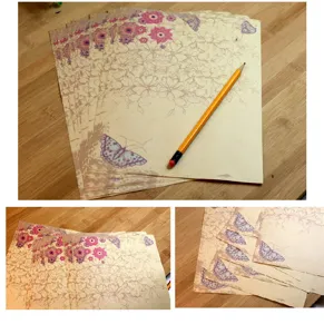 Detailed view of vintage pastoral style letter paper with elegant floral and butterfly patterns.