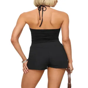 Back detail view of a black backless halter crop top and matching shorts, slim fit design.
