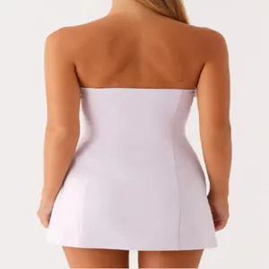 Detailed back view of the elegant lavender strapless mini dress, showing slim waistline.