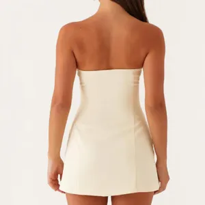 Beige strapless mini dress back view showing slim fit design, elegant summer apparel detail.