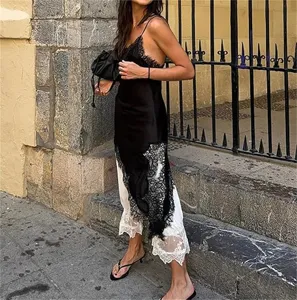 Elegant black satin slip dress with delicate lace trim detail, perfect for chic street style fashion.
