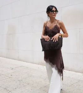 Detailed shot of a brown lace camisole featuring an asymmetrical hem and elegant style.