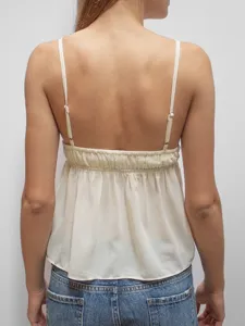 Back view of a stylish beige spaghetti strap camisole top featuring gathered back design.