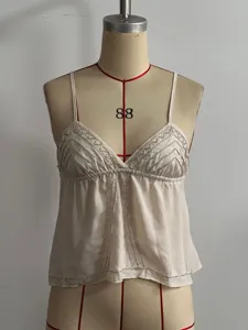 Detail view of the elegant beaded V-neck camisole, featuring delicate silver embroidery.