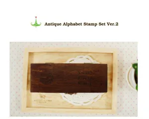 Wooden alphabet and number stamp set in vintage storage box for journaling and crafts.