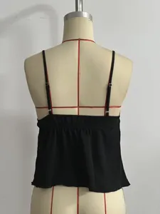 Black camisole top for women featuring adjustable thin straps and a smocked back.