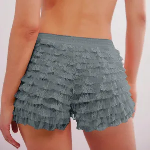 Detail view of women's gray tiered lace ruffled shorts showing layered fabric texture clearly.