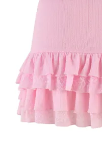 Pink knit skirt detail with layered ruffles and lace trim, sweet Lolita style knitwear close up.