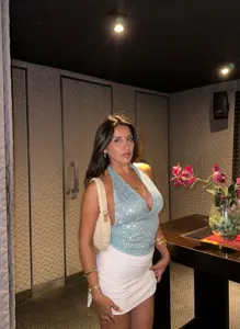 Detailed view of the stylish light blue sequin halter crop top showing backless V-neck style.