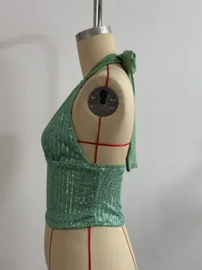 Detailed side view of the green sequin halter camisole top, showing sparkly backless design.