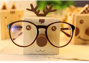 Wooden animal glasses holder detail, cute deer design desk organizer for home office.