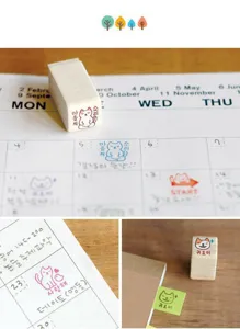 Cute cat wooden stamps detail shown on planner calendar for creative journal decoration.