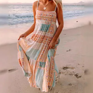 Bohemian style maxi dress beach scene detail showcasing ethnic patchwork print and straps design.