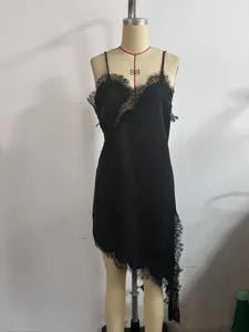 Black silk camisole slip dress detail, featuring elegant asymmetric lace trim and delicate straps.