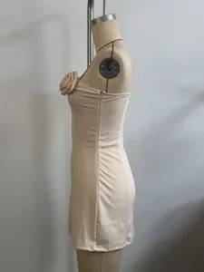 Side detail view of beige strapless mini dress featuring a 3d fabric flower on the bodice.