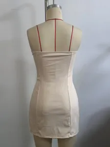 Back detail of beige strapless mini dress with red thin straps, slim fit summer wear.