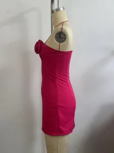 Side detail view of the magenta strapless mini dress featuring a 3d fabric chest flower.