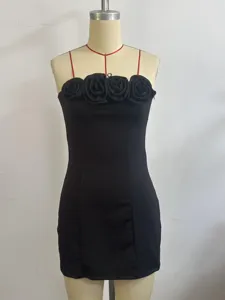 Detailed view of the chic black mini dress featuring 3D fabric roses and thin red straps.