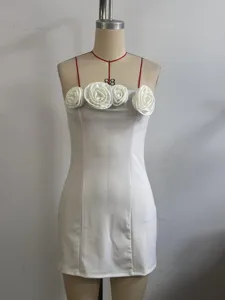 White strapless mini dress detail featuring 3D fabric roses on the bust, sleek summer style.