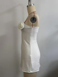 White strapless mini dress side view detail featuring a 3d rose flower and side zipper.