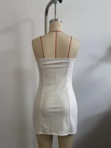 White strapless mini dress back view showing red thin straps and fitted silhouette design.
