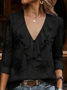 Black V-neck long sleeve blouse detail, elegant ruffle trim and subtle embroidery design.