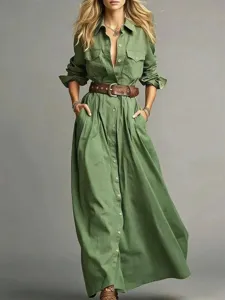 Detail view of solid green long sleeve shirt dress with button closure and brown leather belt.