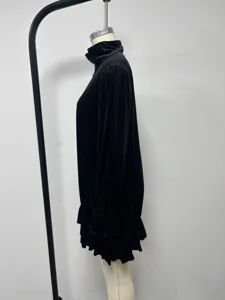 Detail view of black crystal velvet long sleeve dress featuring stand collar and ruffles.