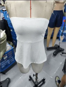White strapless tube top for women, textured fabric, slim fit design, stylish summer wear detail.