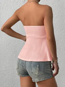 Back view detail of the solid pink strapless tube top, stylish streetwear outfit inspiration.