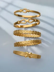Luxury gold-plated stainless steel stackable bracelets with floral and geometric designs for women.
