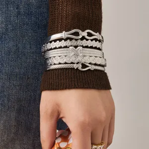 Silver stainless steel stacked bracelets set with floral texture and geometric buckle design.
