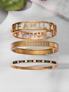 Gold stainless steel stackable bracelets set featuring cutout family letters and sparkling zircons.