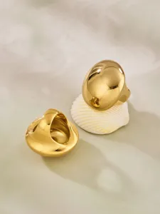Close-up view of chic chunky gold dome geometric ring detail showcasing glossy polished surface.