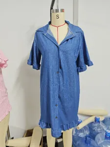 Denim shirt dress detail showcasing lapel collar, single-breasted buttons, and ruffle sleeve cuffs.