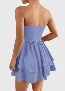 Back view detail of women's strapless tiered mini dress, showing textured fabric and ruffles.