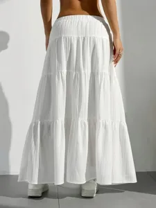 Detailed view of white tiered maxi skirt, back view showing gathered elastic waistband.