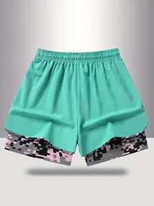 Detail view of women fake two-piece sports shorts in mint green with pixel camo inner layer.