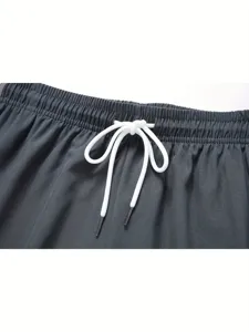 Close-up detail shot of the elastic waistband and white drawstring on casual sports shorts.