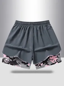 Women's fake two-piece sports shorts with digital camo inner layer and elastic waist.