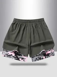 Women's fake two-piece athletic sports shorts with camouflage inner layer and elastic waist.