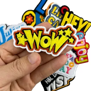 Detailed shot of colorful embroidered patches, featuring vibrant alphabet and slogan designs.