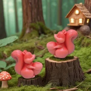 Detail shot of cute squirrel holding pinecone silicone mold and aromatherapy candle setting forest.