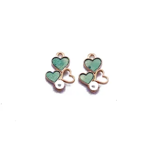 Pearlescent heart drip oil DIY alloy earring pendant detail view with green glitter finish.