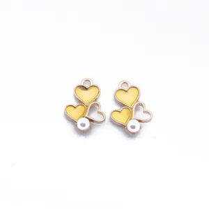 DIY alloy heart pendants with yellow enamel and pearl charm for earrings and jewelry making.