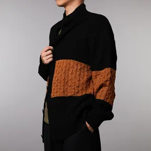 Close-up view of the men's color-block knit cardigan showing textured brown chest panel.