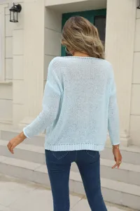 Back view detail of light blue hollow-out knit sweater showcasing texture and casual style.