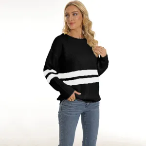 Detailed view of women black and white striped knit sweater pullover worn by female model.