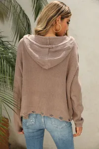 Back view detail of women brown knit hooded sweater with distressed hem and casual cozy style.