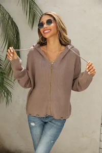 Close-up of women's knitted zip-up hoodie with distressed hem and casual styling.